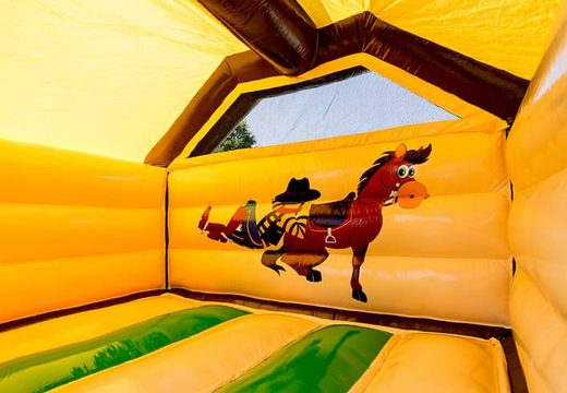 Opblaasbare slide combo springkasteel in thema cowboy te koop voor kinderen. Bestel nu opblaasbare springkastelen met glijbaan bij JB Inflatables Nederland
