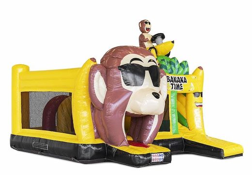 Opblaasbaar springkussen met obstakels erin en een glijbaan in bananen apen thema bestellen